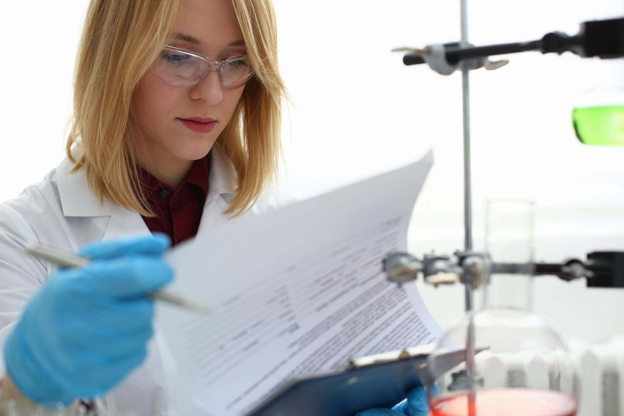 A researcher working in a fragmented laboratory environment where disconnected equipment and manual data silos create operational bottlenecks.